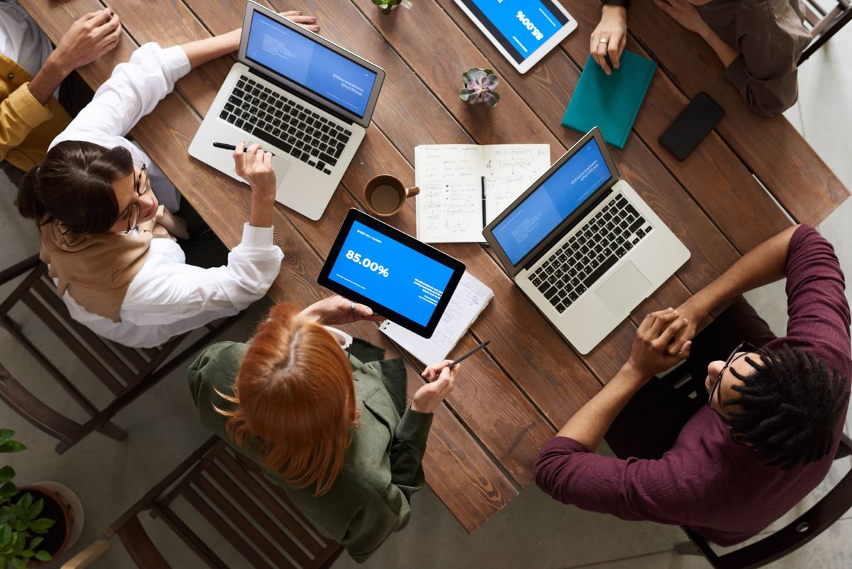 Two women working together on software programming indoors, focusing on code.